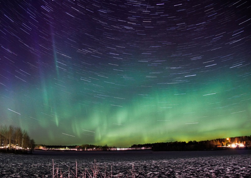 Stars and aurora borealis blending in the sky